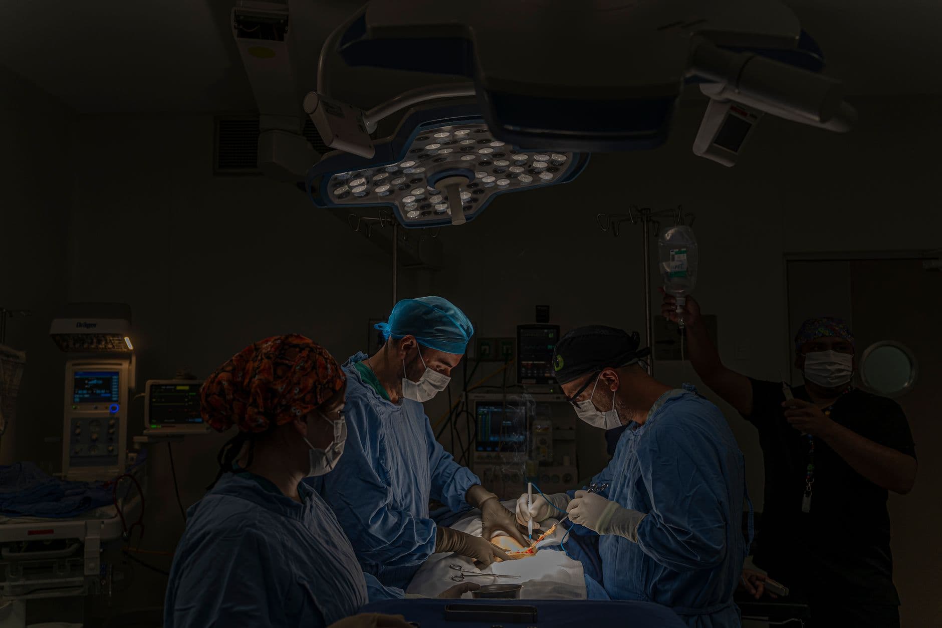 A surgical team conducts an operation in a well-equipped hospital operating room in Mexico.
