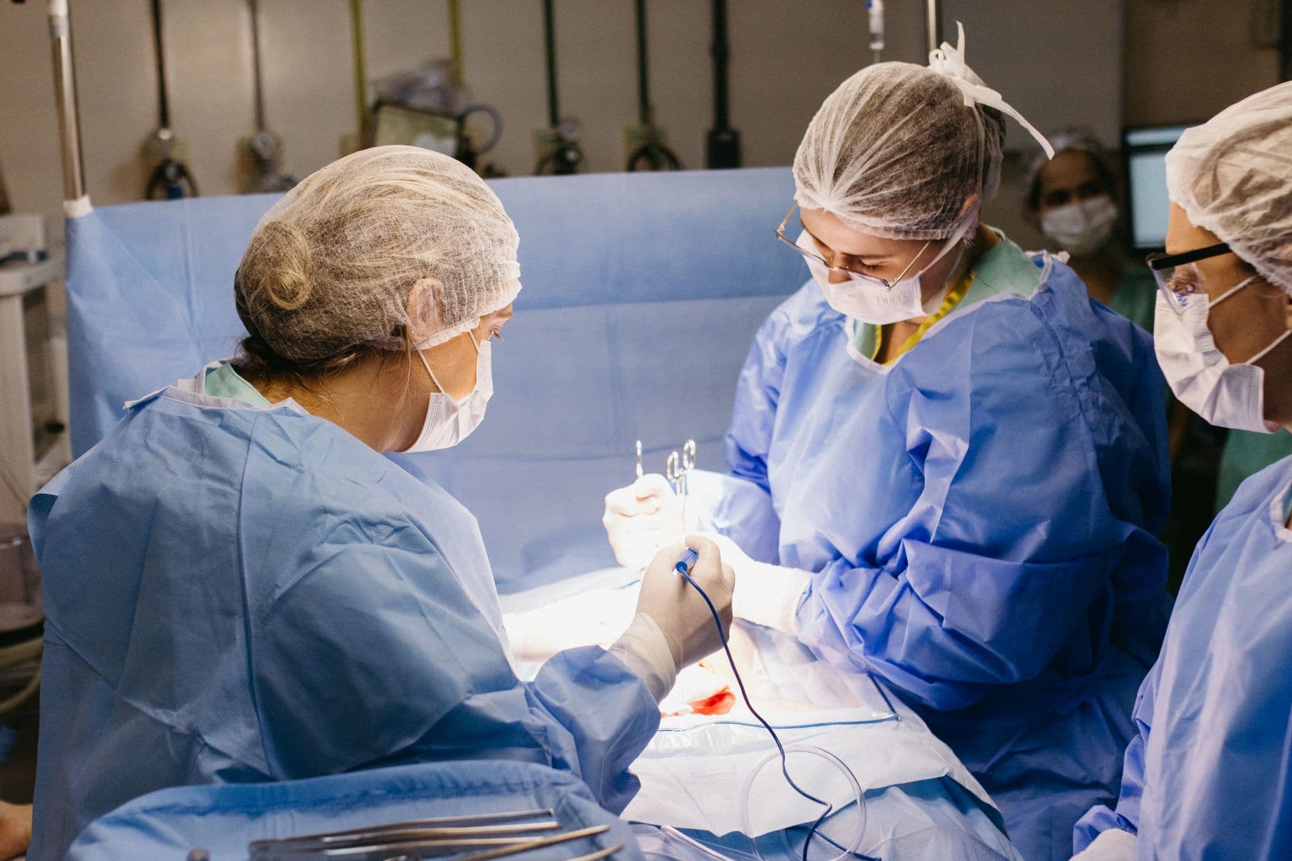 Medical professionals performing surgery in a sterile environment, showcasing teamwork and precision.
